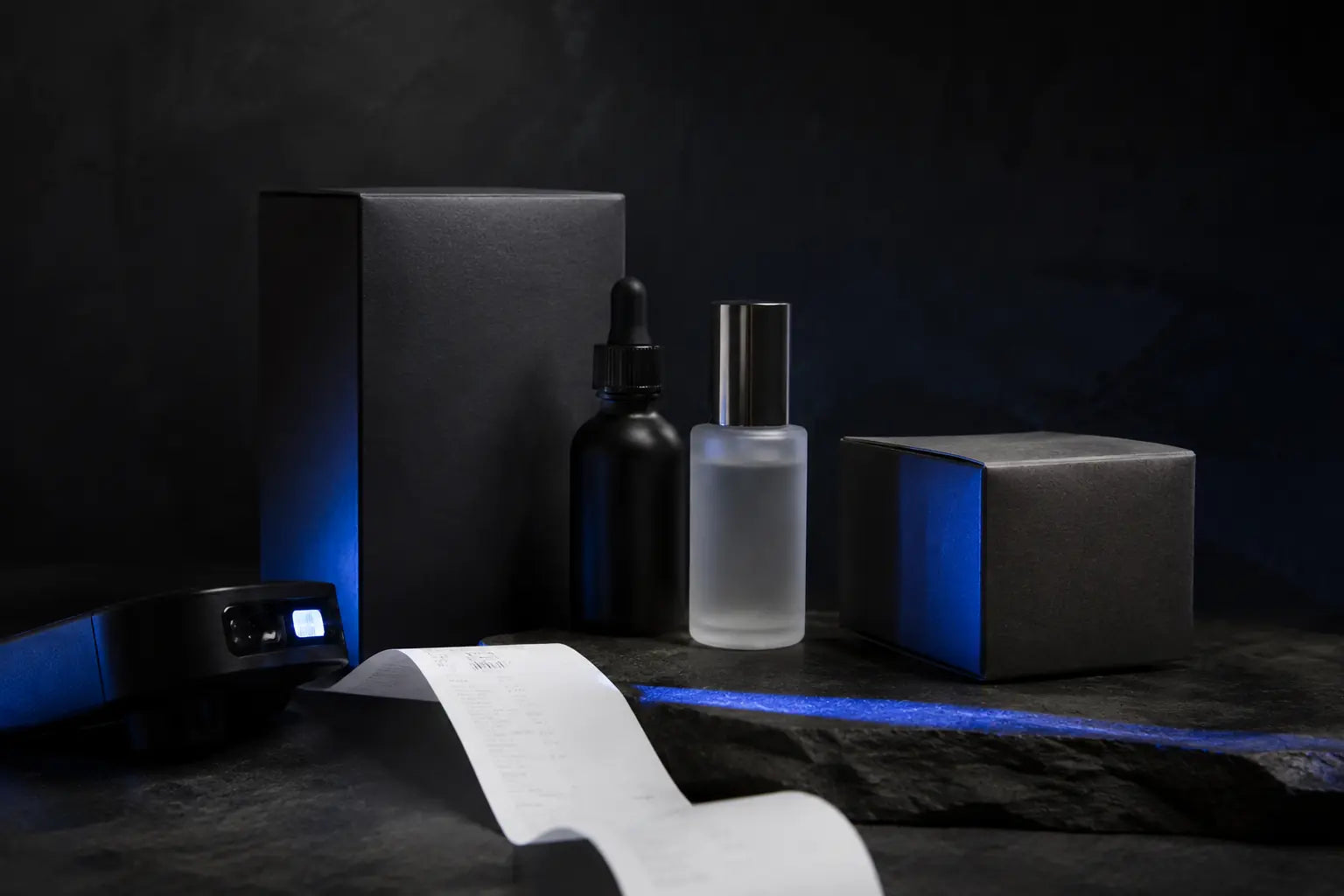 Unbranded product packages, frosted bottles, a receipt, and scanner light on a retail studio table